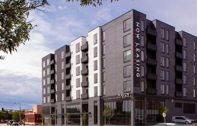 a large apartment building on a city street at Maven on Broadway, Rochester, 55904