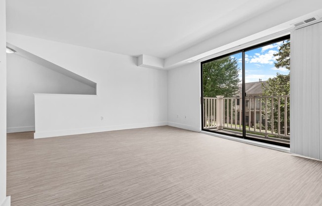 a bedroom with a large window and a balcony