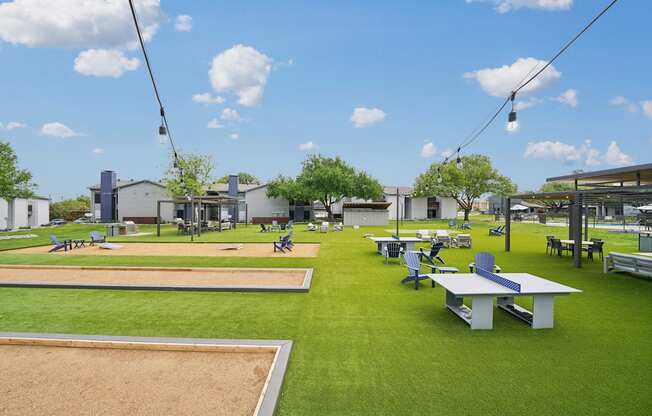 a park with picnic tables and benches on the grass