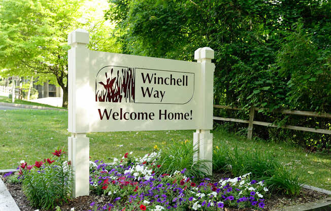 A sign that says Winchell Way Welcome Home.