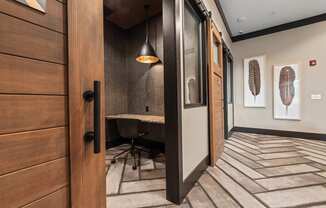 a conference room with a desk and a door to a hallway