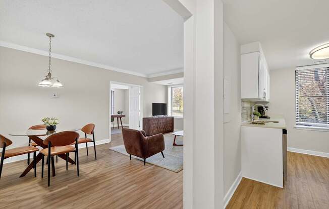 A living room with a dining table and chairs.