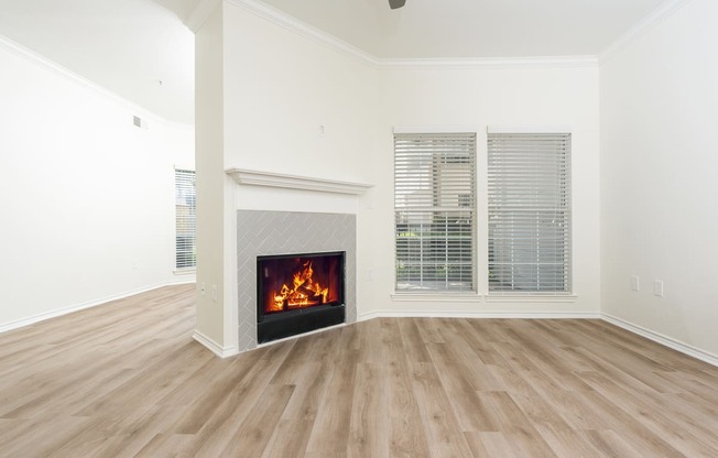 a living room with a fireplace and a large window