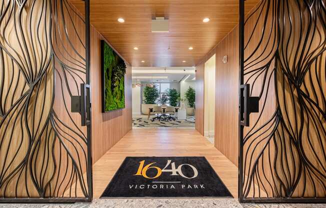 a hotel lobby with wooden doors and a sign that reads 160 victory park