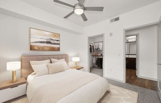 a bedroom with a large bed and a ceiling fan