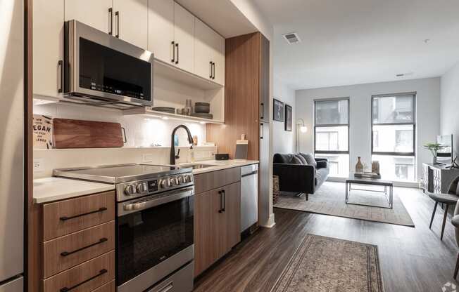 a kitchen with wooden cabinets and a stove and a microwave