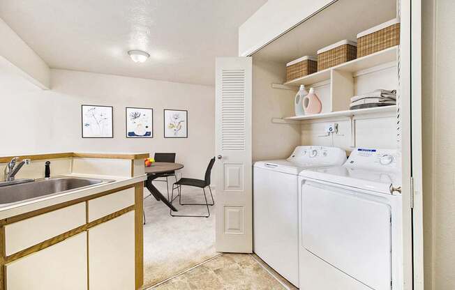 A kitchen with a washer and dryer at South Bridge Apartments in Fort Wayne, IN