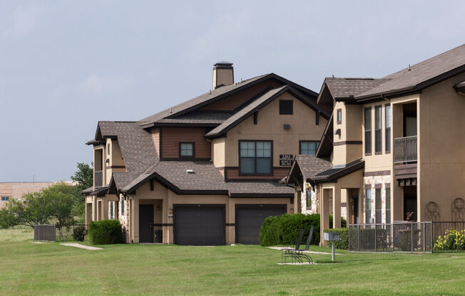 A large house with a brown roof and a garage door.