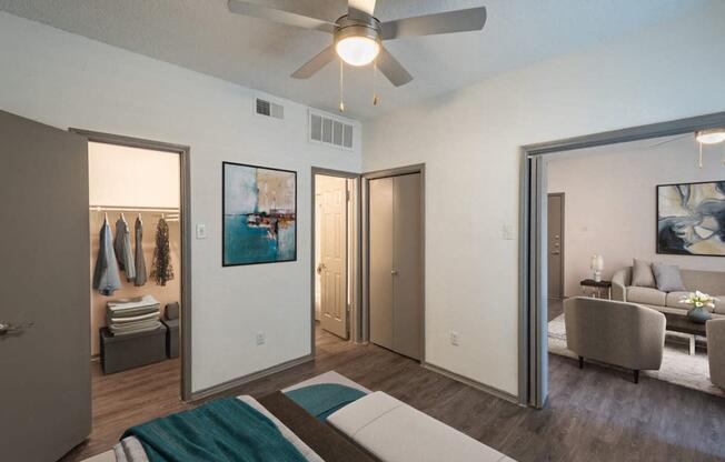 a living room with a ceiling fan and mirrors