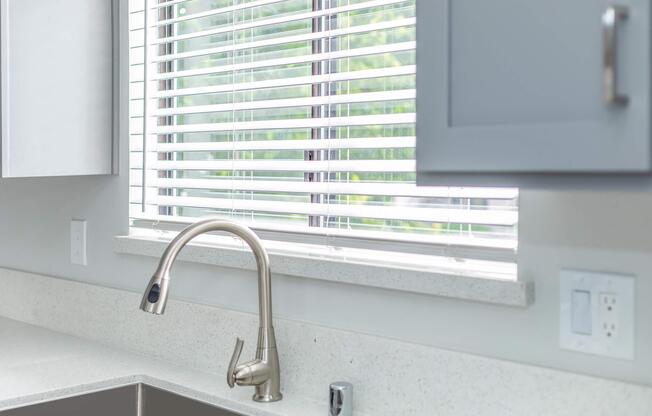 a sink sitting under a window