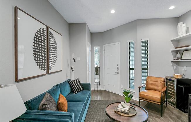 a living room with a blue couch and a coffee table