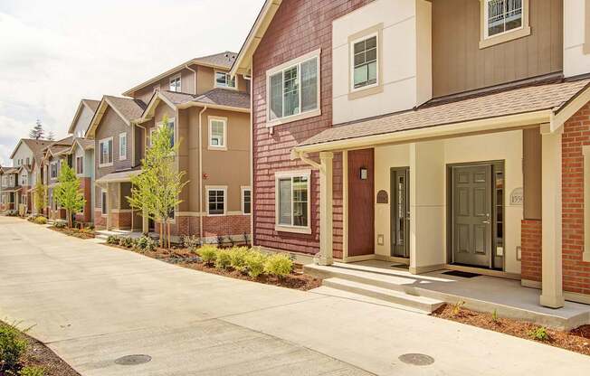 A row of houses with brown and beige exteriors.