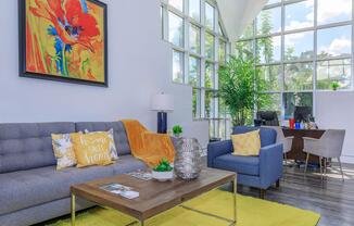 a living room filled with furniture and a large window