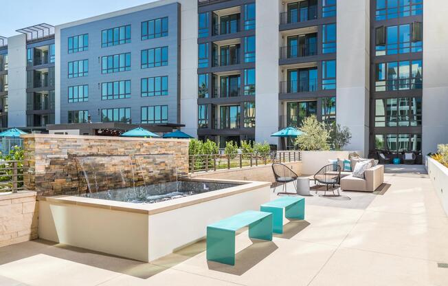 Outdoor lounge with bar seating and fire feature for evening gatherings.