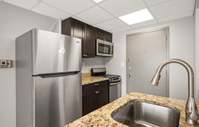 a kitchen with stainless steel appliances and granite counter tops