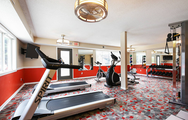 a gym with treadmills and other exercise equipment at the enclave at university crossings