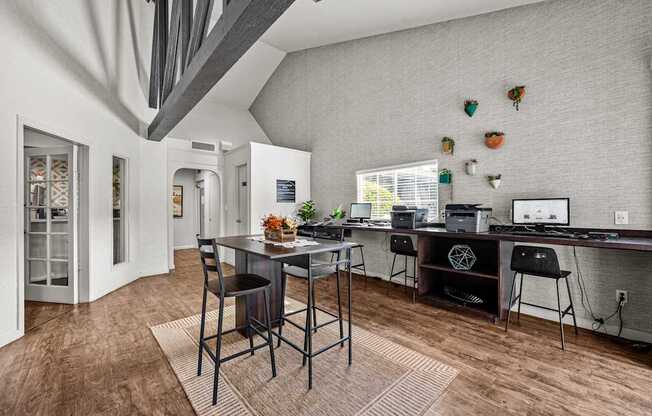 A modern kitchen with a dining table and chairs in the foreground.