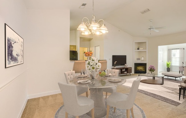 a dining room with a table and chairs and a living room