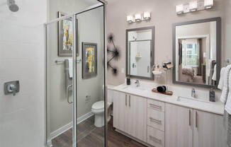 Glass enclosed shower and double vanity sinks
