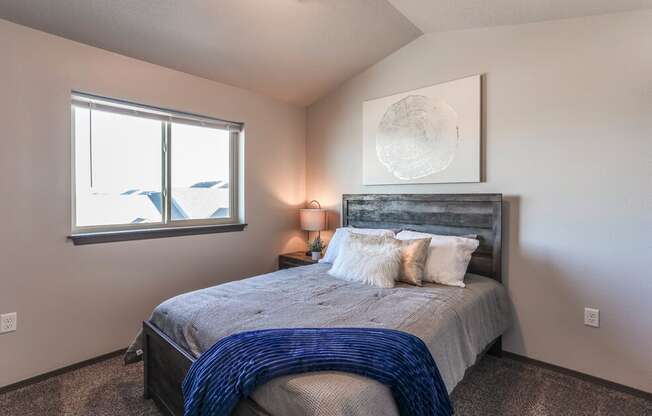 Unfurnished bedroom featuring vaulted ceilings and a walk-in closet.