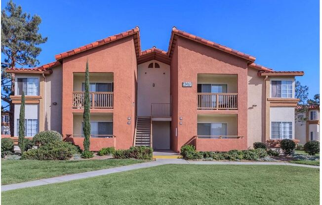 an apartment building with a sidewalk in front of it at Riverview Springs, Oceanside, CA,92058