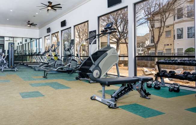 the residence apartments fitness room with exercise equipment