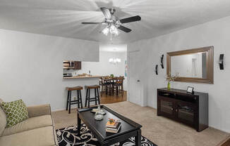 a living room with a couch and a ceiling fan