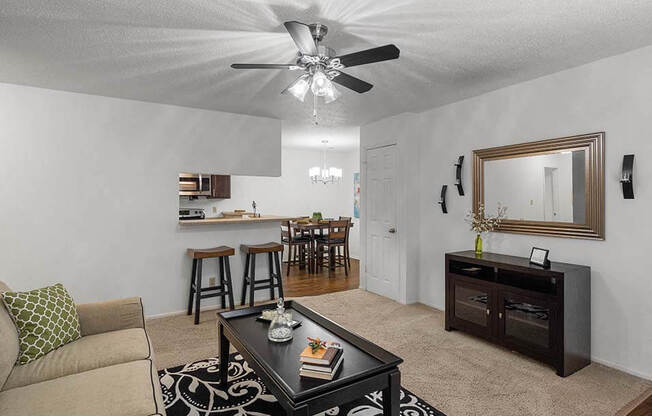 a living room with a couch and a ceiling fan