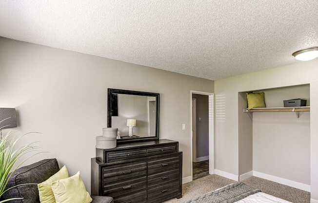 a living room with a couch and a dresser and a mirror