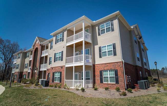 A large apartment building with multiple balconies and windows.