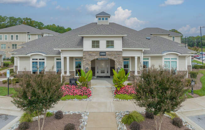 a large house with a driveway and landscaping in front of it