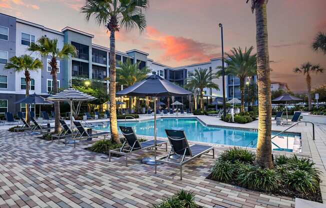 a swimming pool at a resort with palm trees