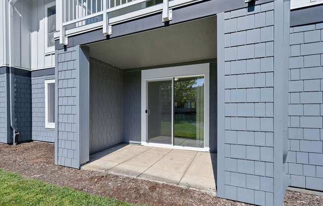 a covered patio with a sliding glass door