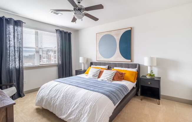 a bedroom with a large bed and a ceiling fan