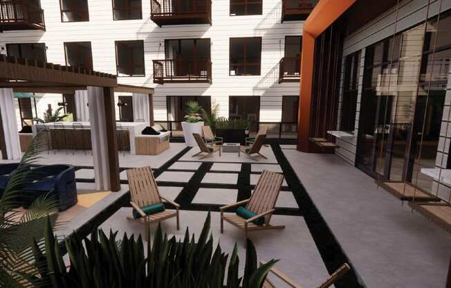 a courtyard with chairs and tables and a building in the background