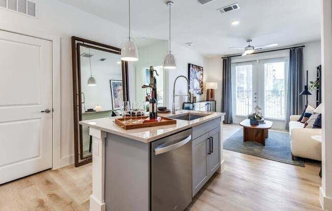 A modern kitchen with a wooden island and stainless steel appliances.