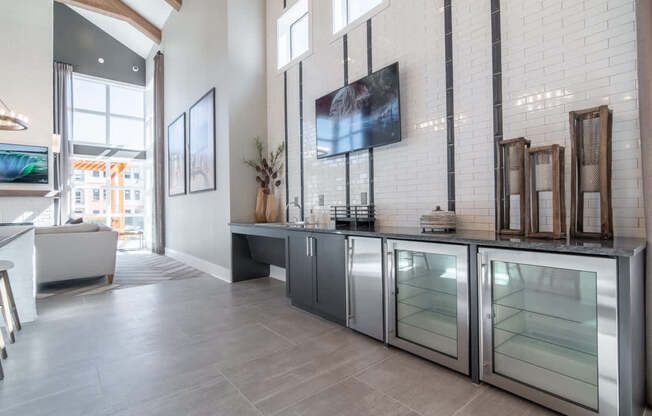 a kitchen with stainless steel appliances and a tv on the wall