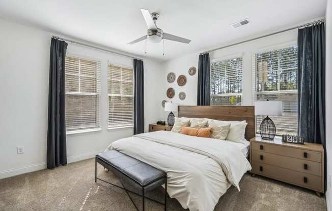 a bedroom with a bed and a ceiling fan