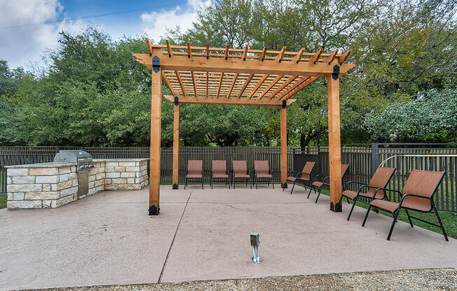 a patio with a wooden pavilion and benches at The Broadwater at Salado Creek, San Antonio, TX, 78216