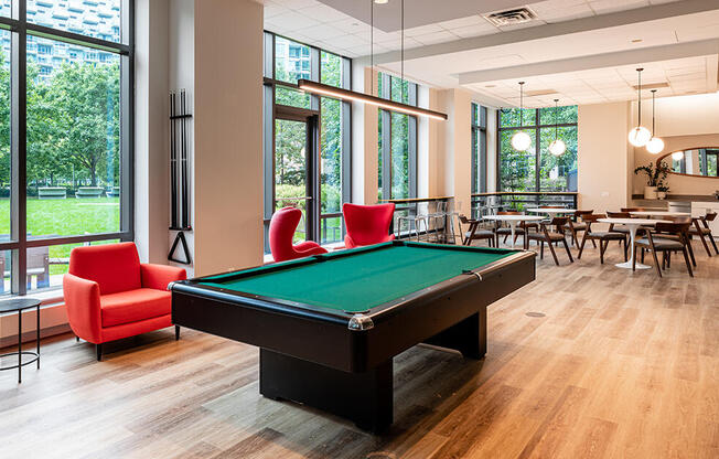 Pool table and dining amenities for residents at 4720 Center Blvd. 