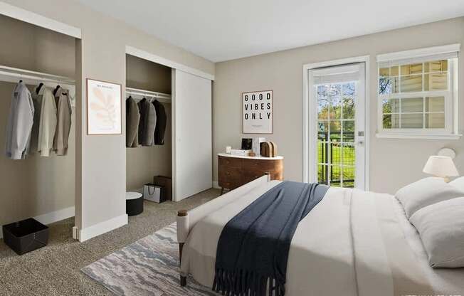 A bedroom with a bed, a dresser, and a window with a view of trees.