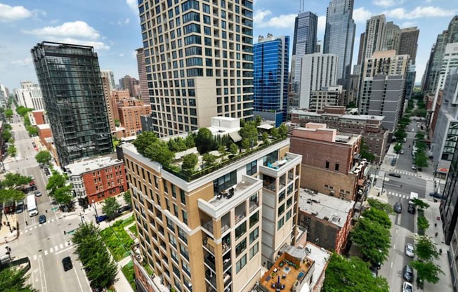 an aerial view of a city with trees on top of buildings