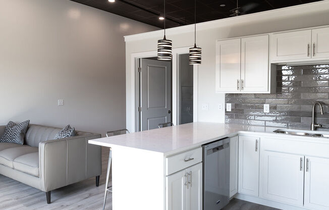 a white kitchen with white cabinets and a white counter top