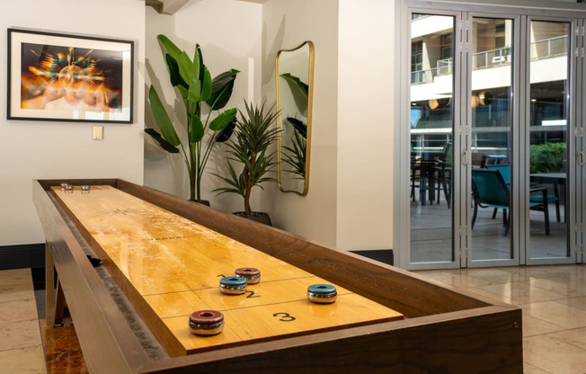 shuffle board a game room with a door to a patio