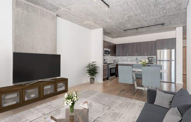 a living room and dining room with a couch and a tv at One 333, Chicago, IL, 60605