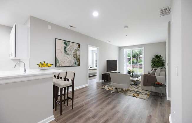 an open living room with a kitchen and a living room