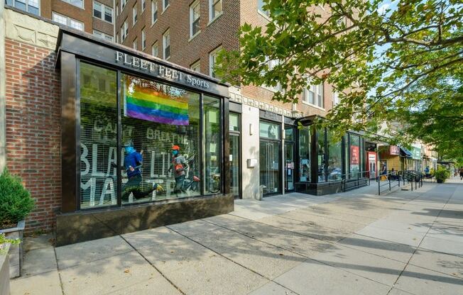 a store front with a rainbow sign in the window