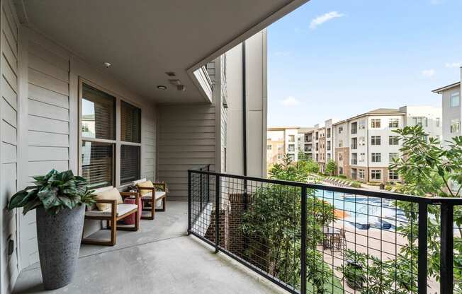 a balcony with a pool and a patio