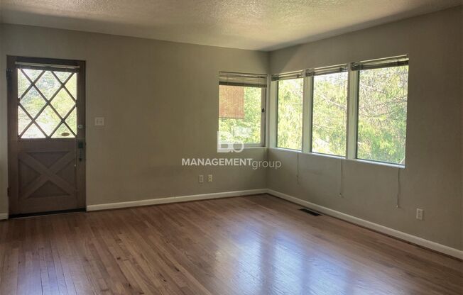 Spacious Multnomah Village Duplex sits amongst a treetop setting. Fenced Backyard. Landscaping Included!