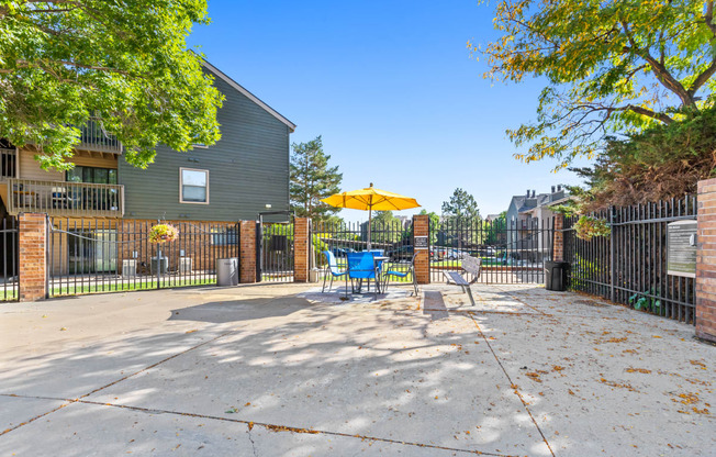 our yard is big and has a table and chairs with an umbrella